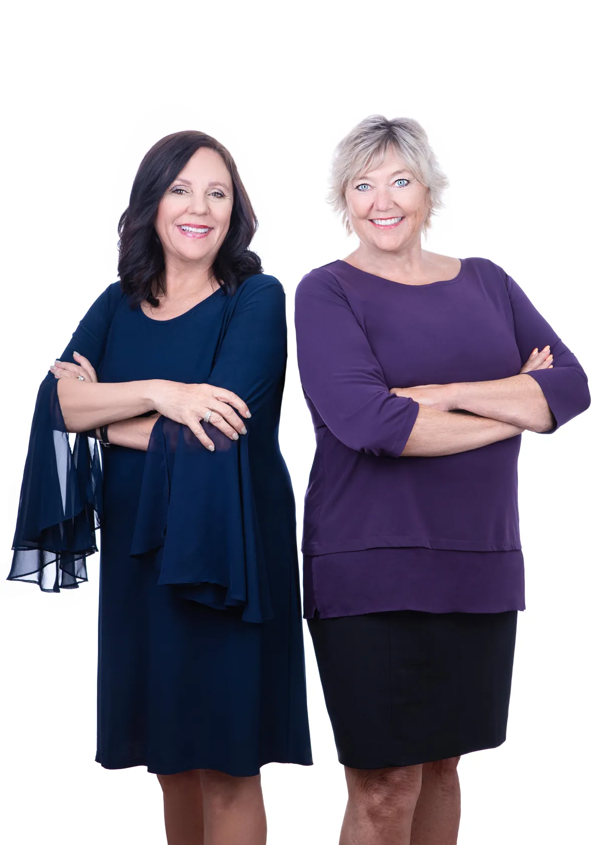 Two women standing next to each other with their arms crossed.