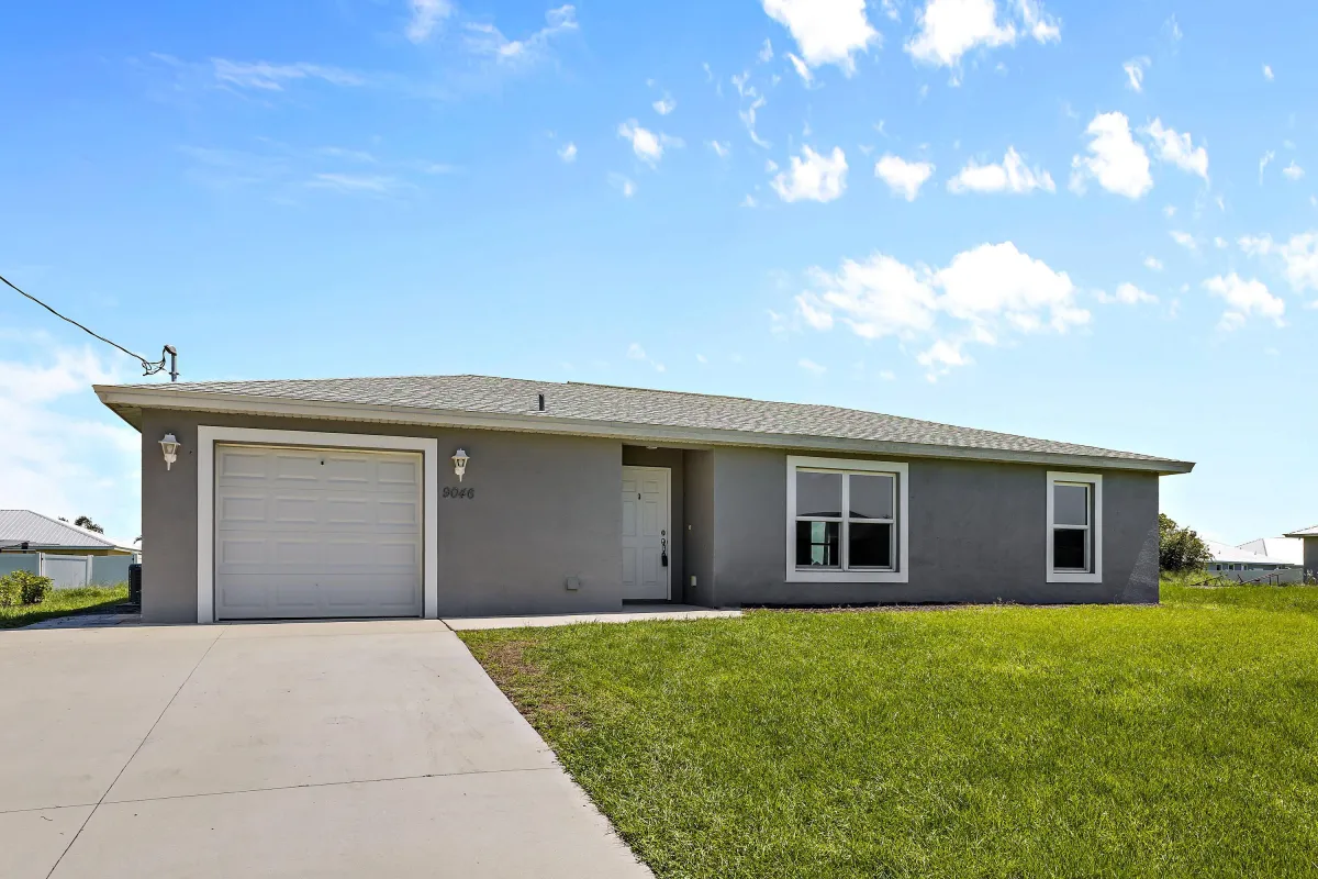 A house with grass and sky in the background