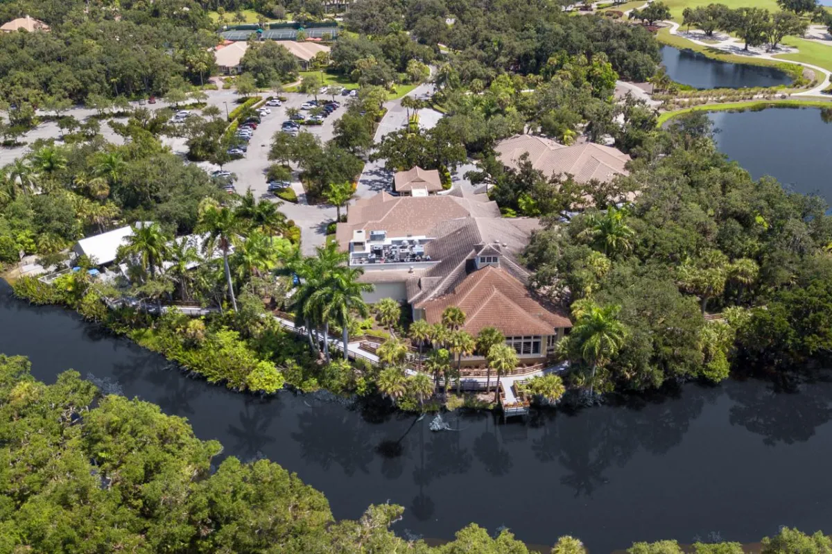 A bird 's eye view of a resort with trees and water.