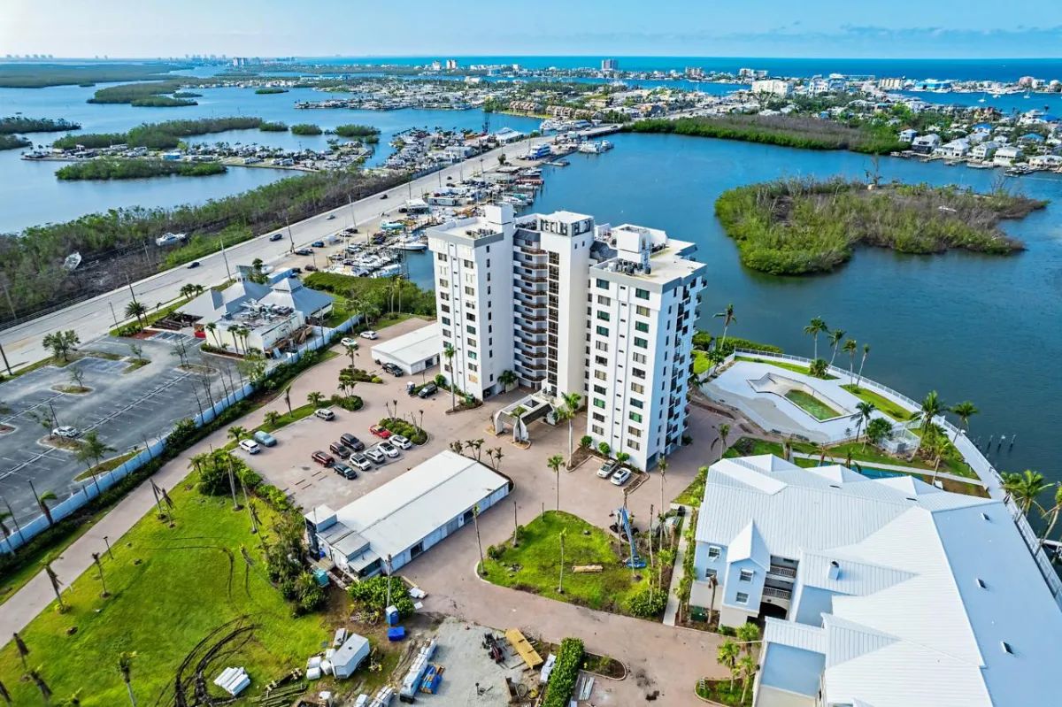 A view of the water from above shows buildings, boats and a marina.