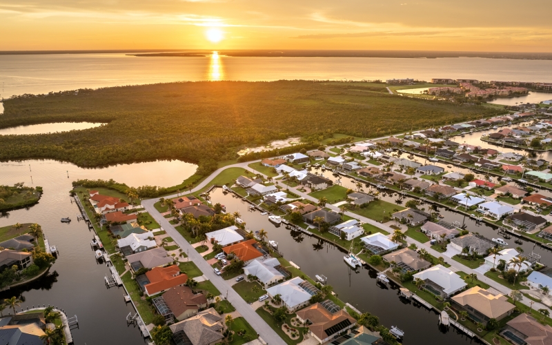 Evening glow over Punta Gorda, Florida. Waterfront with luxurious houses, palm trees and peaceful suburban atmosphere