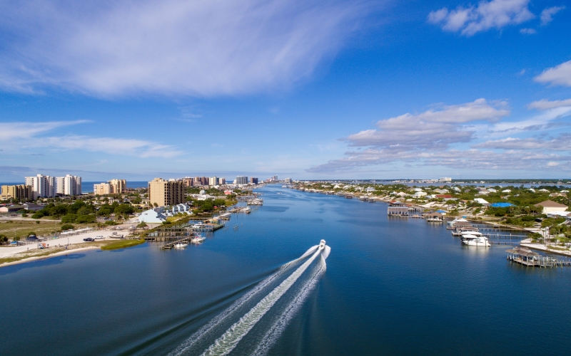 scenic-waterway-with-boat-near-urban-waterfront-2026-03-18-13-50-17-utc